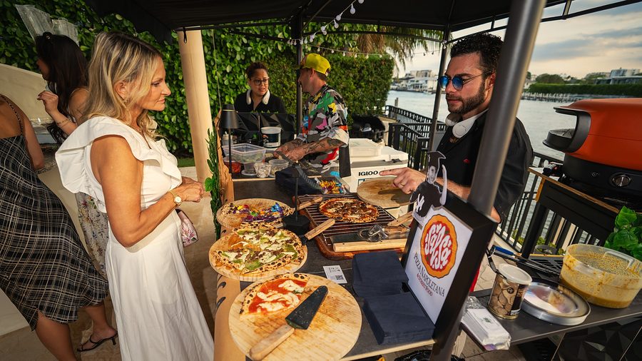 Guests at Chef Mike's live pizza station on the water